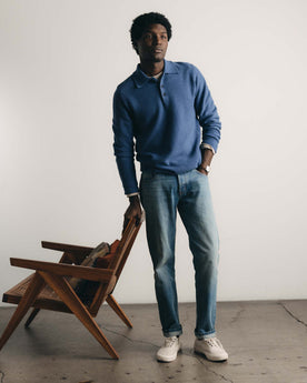 fit model posing in The Newton Sweater Polo in Heather Clear Blue, Knits by Taylor Stitch