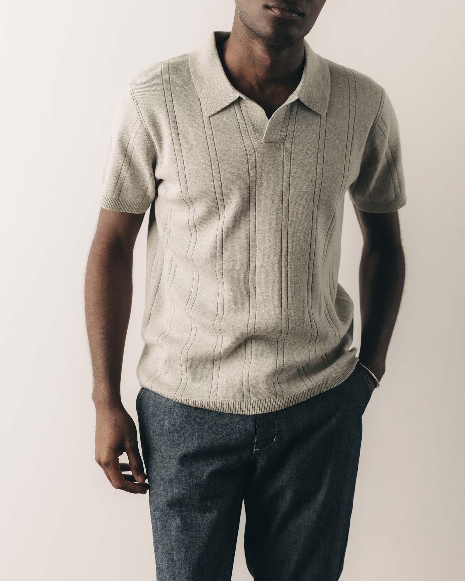 fit model posing in The Valencia Sweater Polo in Heather Grey Rib, Knits by Taylor Stitch