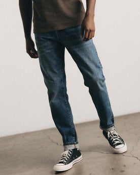 fit model walking wearing The Slim Jean in Mid Wash Organic Selvedge, Bottoms by Taylor Stitch