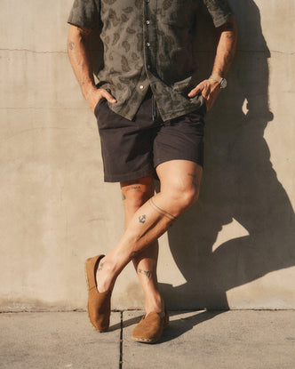 fit model posing in The Apres Short in Organic Faded Black Foundation Twill