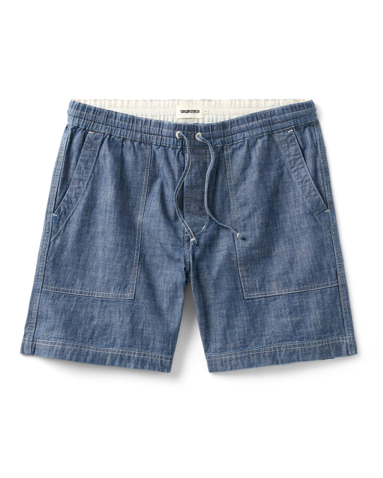 flatlay of The Breakwater Short in Washed Indigo Chambray, Bottoms by Taylor Stitch