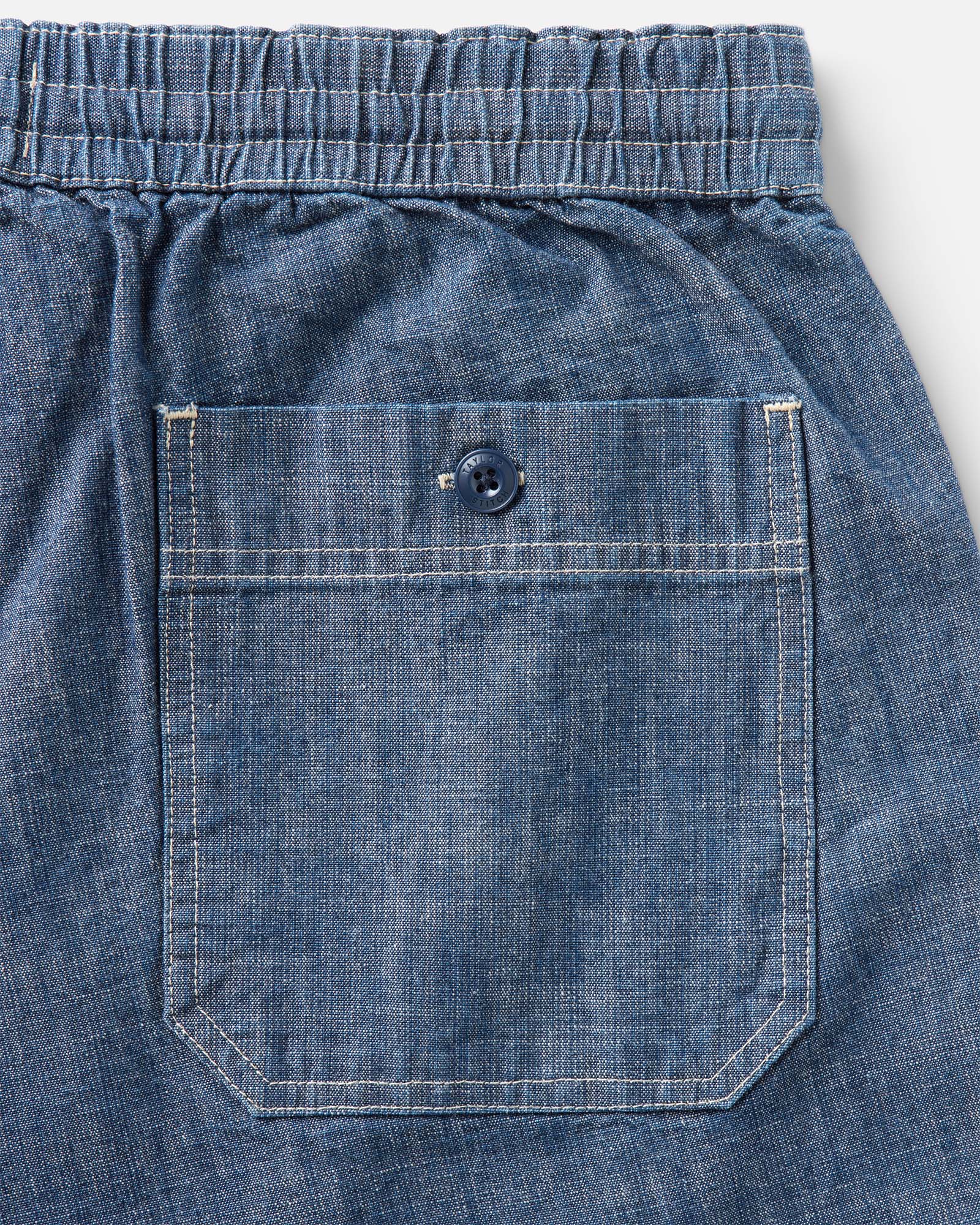 material shot of the back pocket on The Breakwater Short in Washed Indigo Chambray, Bottoms by Taylor Stitch