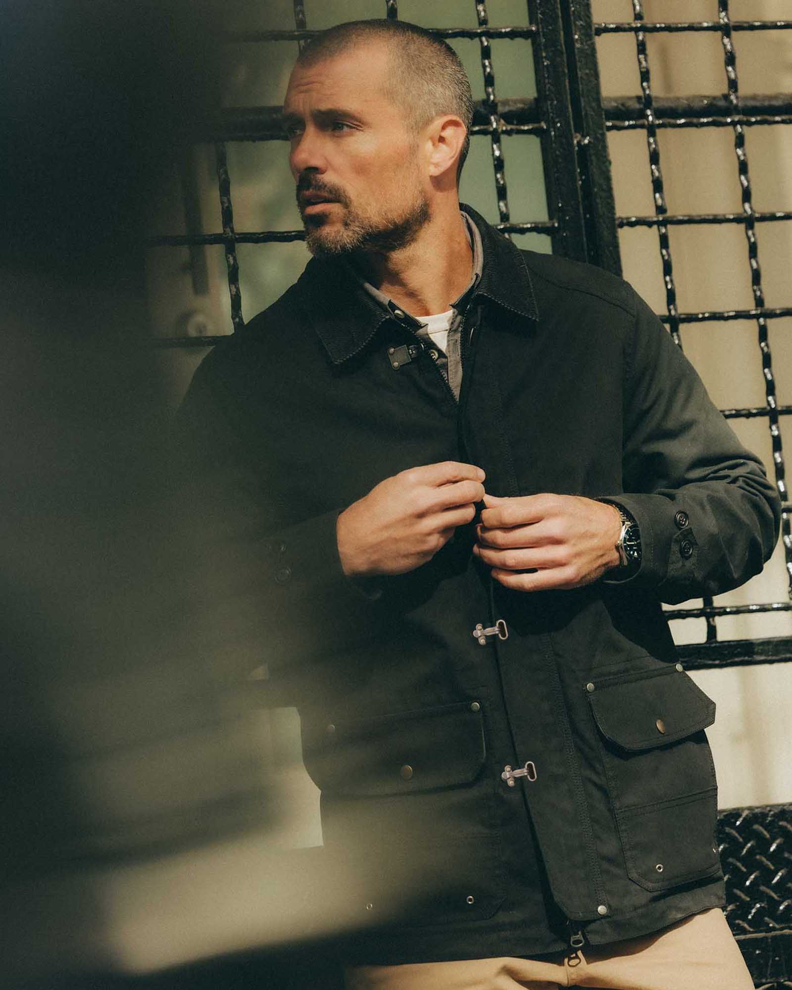 fit model posing in The Cinder Jacket in Coal Dry Wax, Outerwear by Taylor Stitch