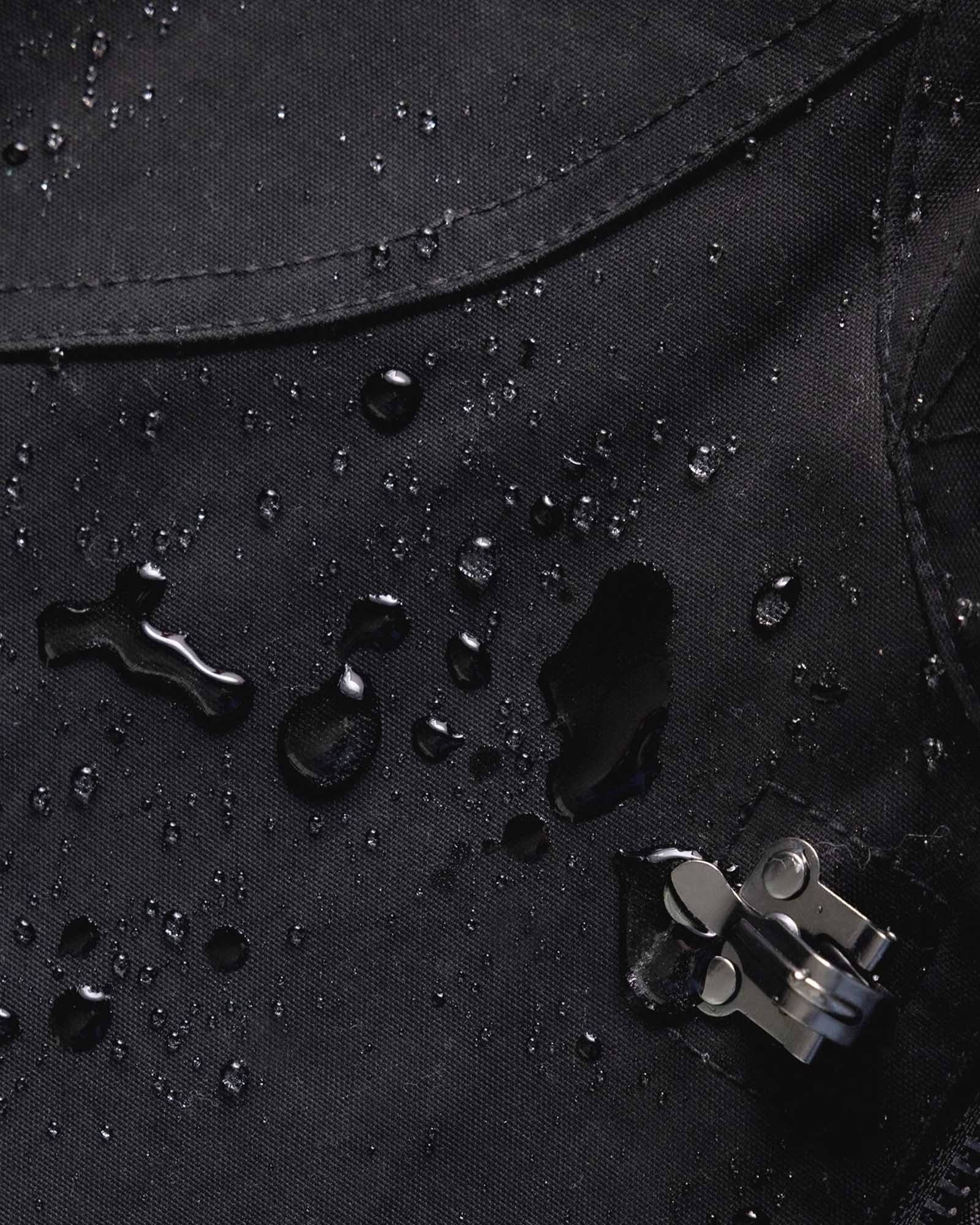 material shot of water droplets on The Cinder Jacket in Coal Dry Wax, Outerwear by Taylor Stitch
