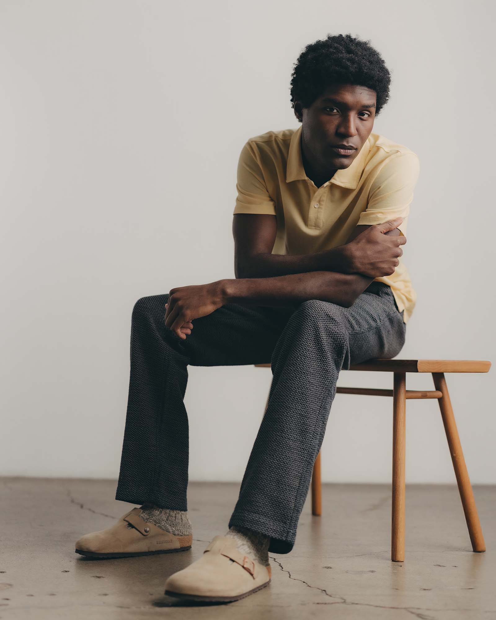 fit model sitting wearing The Cotton Hemp Polo in Straw Pique, Knits by Taylor Stitch