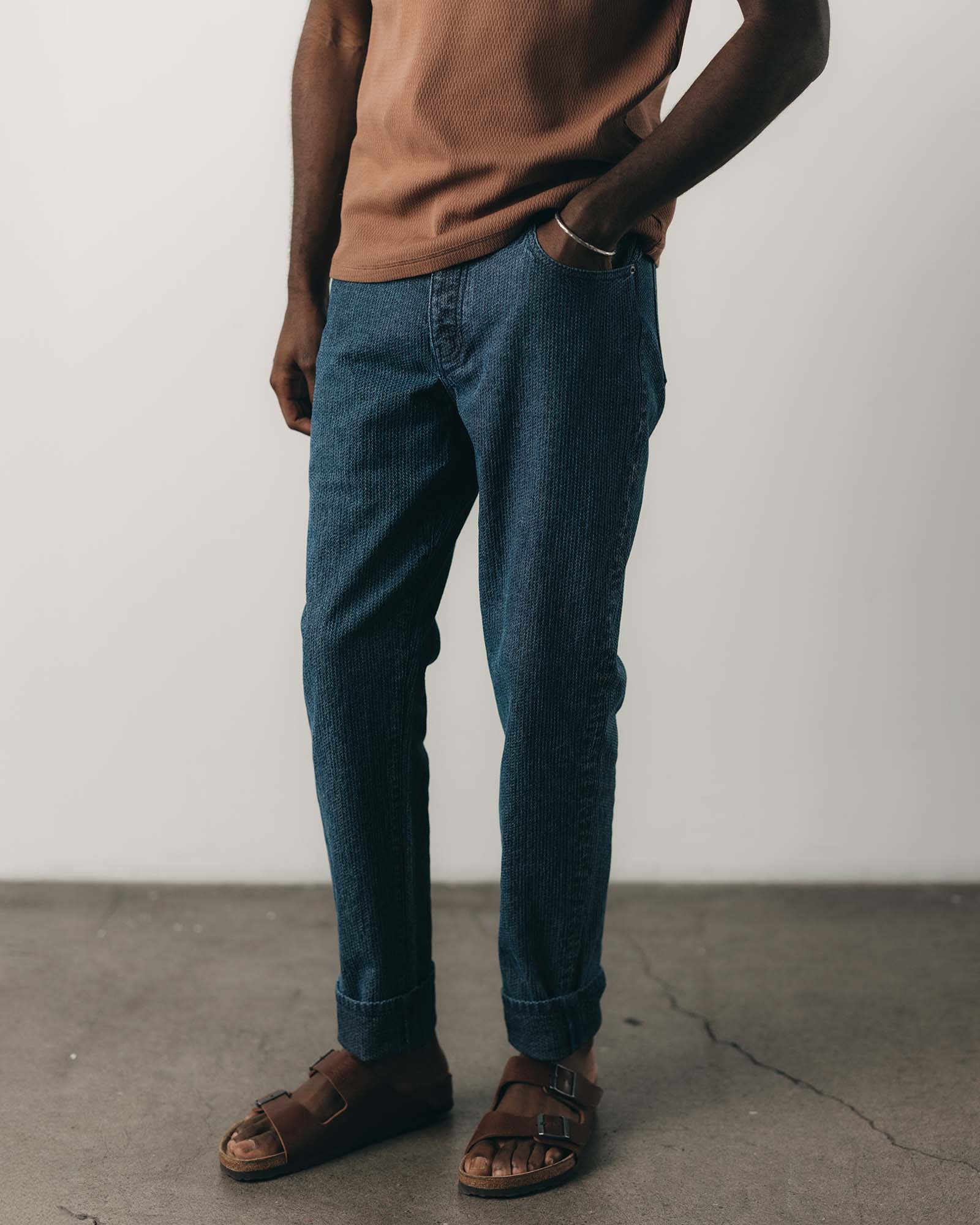 fit model with his hand in his pocket wearing The Democratic Jean in Japanese Washed Indigo Sashiko, Bottoms by Taylor Stitch