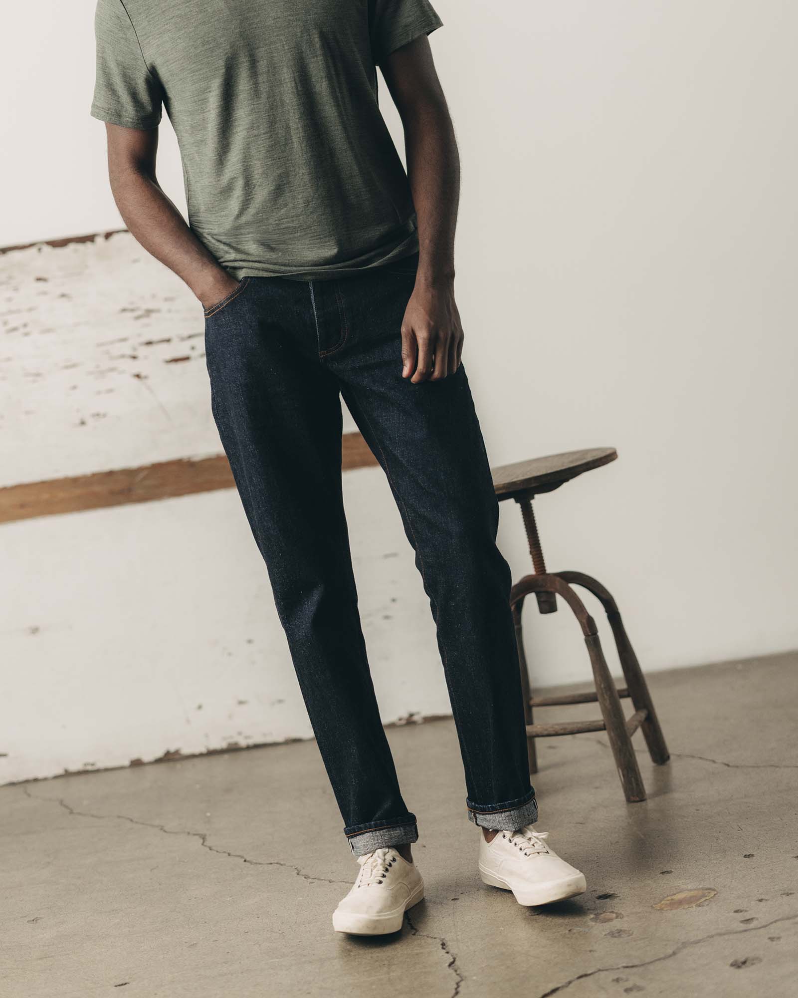 fit model showing off The Democratic Jean in Rinsed Yoshiwa Selvedge, Bottoms by Taylor Stitch