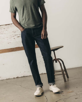 fit model showing off The Democratic Jean in Rinsed Yoshiwa Selvedge, Bottoms by Taylor Stitch