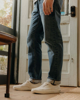 fit model walking wearing The Democratic Jean in Mid Wash Organic Selvedge, Bottoms by Taylor Stitch