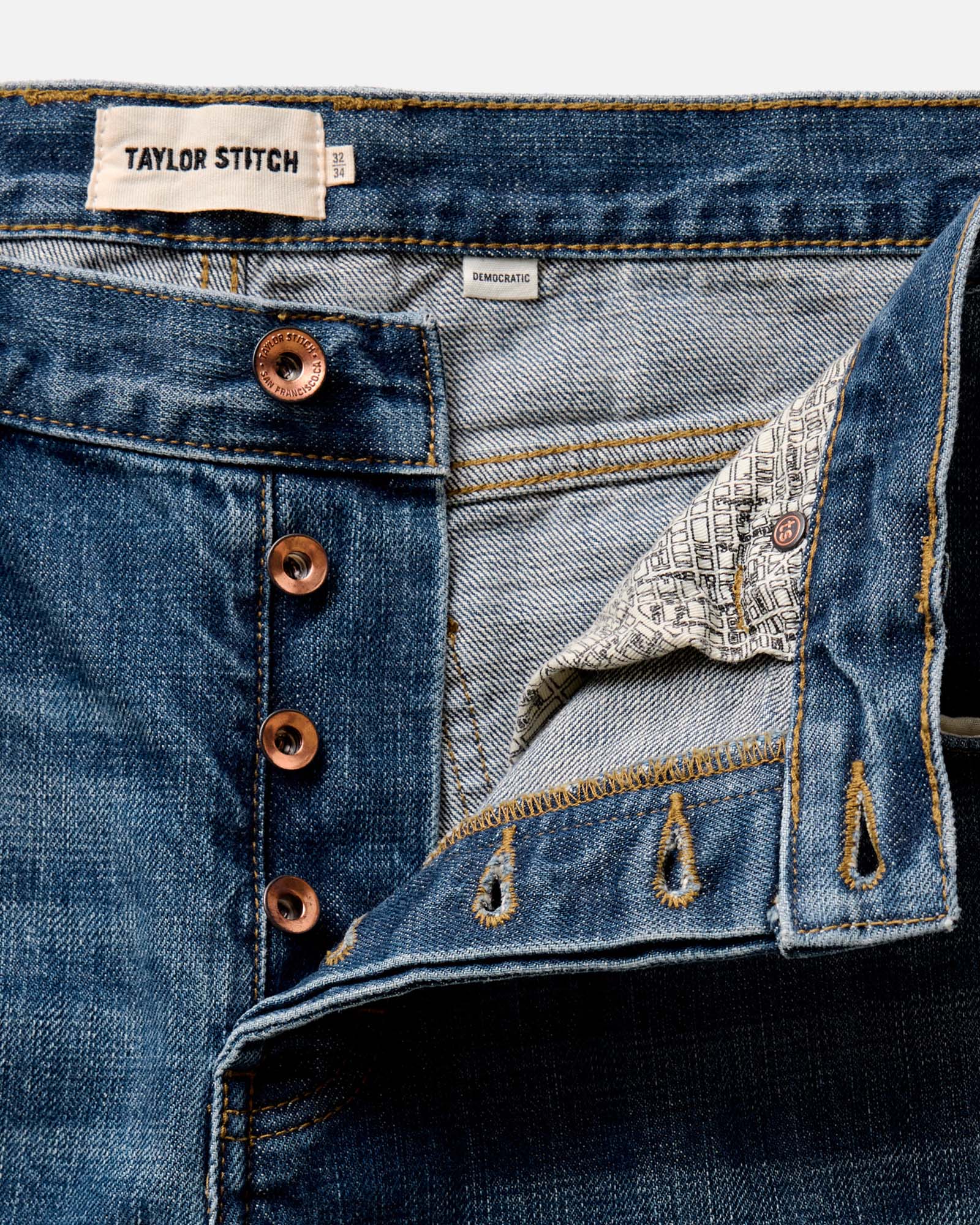 fit model showing off the back of The Democratic Jean in Mid Wash Organic Selvedge, Bottoms by Taylor Stitch