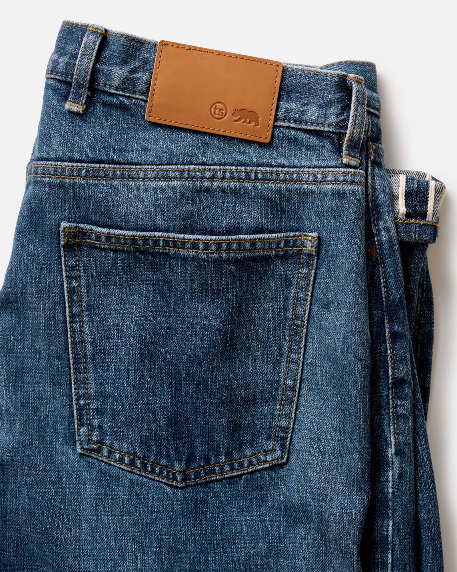 flatlay of The Democratic Jean in Mid Wash Organic Selvedge, Bottoms by Taylor Stitch