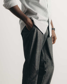 fit model with his hand in his pocket wearing The Easy Pant in Black Indigo Chambray, Bottoms by Taylor Stitch