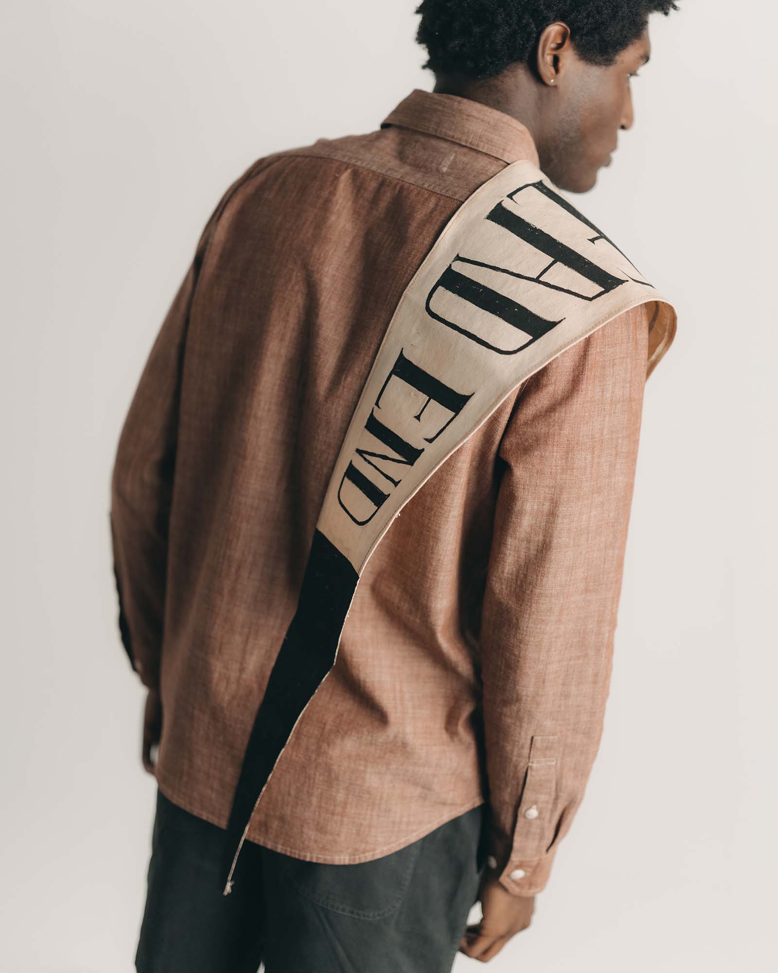 fit model posing in The Foundry Shirt in Brick Chambray, Wovens by Taylor Stitch