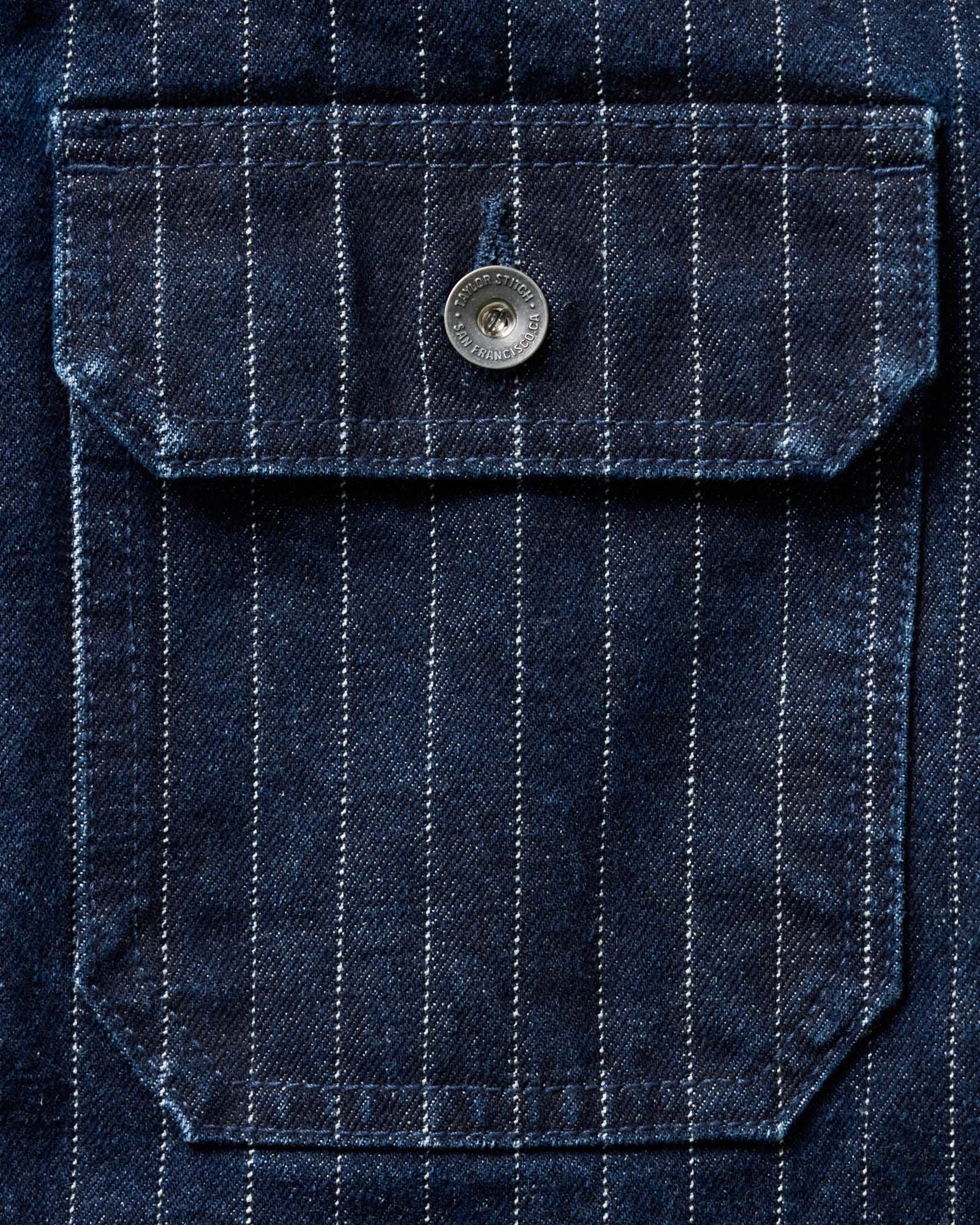 material shot of the pocket on The Fremont Jacket in Rinsed Indigo Dobby Denim, Outerwear by Taylor Stitch
