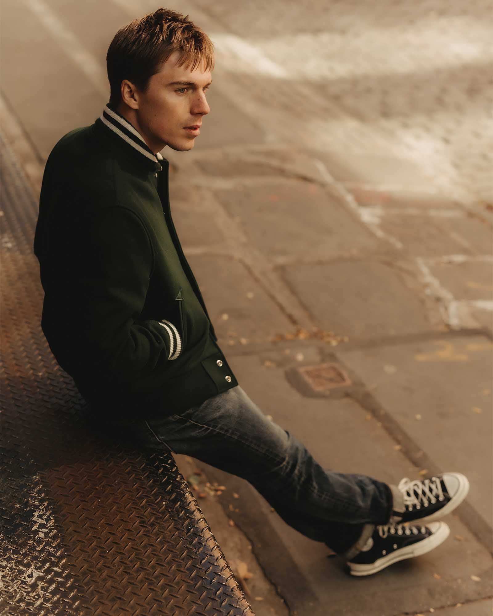 fit model sitting wearing The Golden Bear Snap Bomber in Ivy Wool, Outerwear by Taylor Stitch