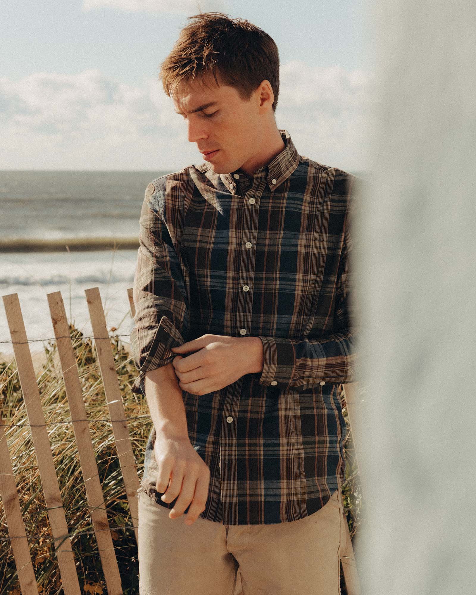 fit model adjusting the sleeve on The Jack in Atlantic Blue Madras, Wovens by Taylor Stitch