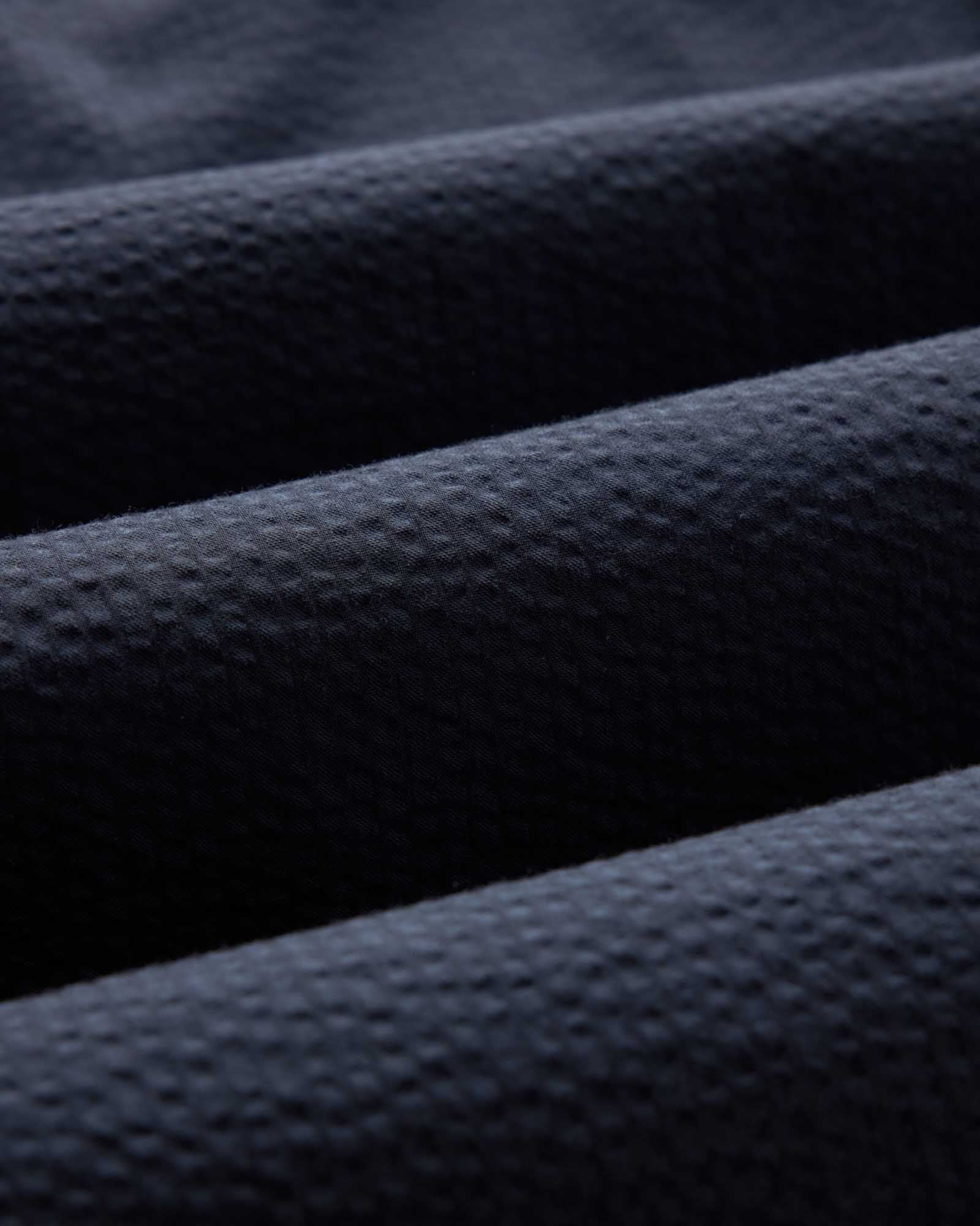 material shot of the seersucker fabric on The Jack in Dark Navy Seersucker, Wovens by Taylor Stitch