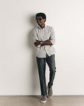 fit model leaning against the wall wearing The Jack in Navy Stripe Seersucker, Wovens by Taylor Stitch