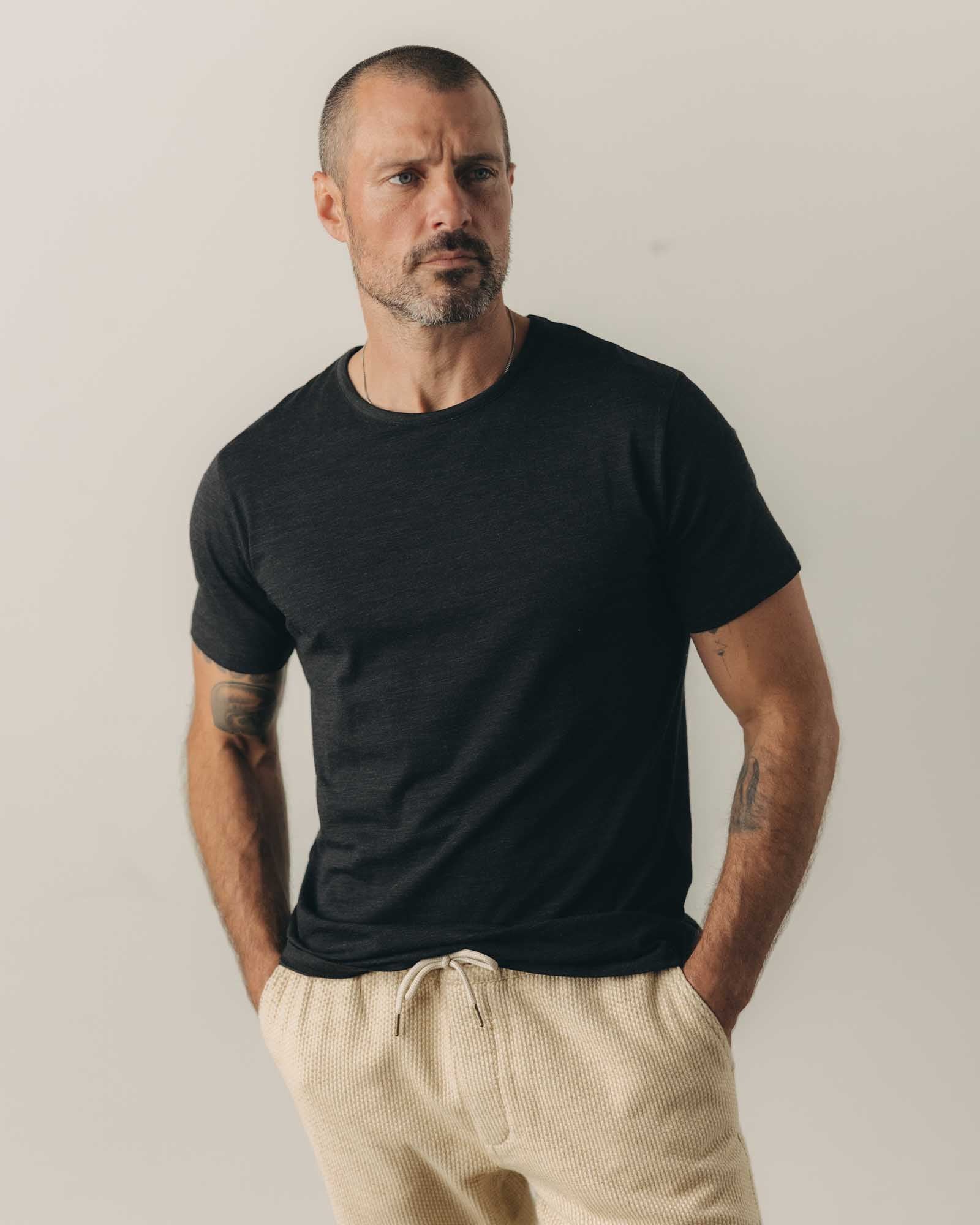fit model showing off the shoulders on The Merino Tee in Heather Black, Knits by Taylor Stitch