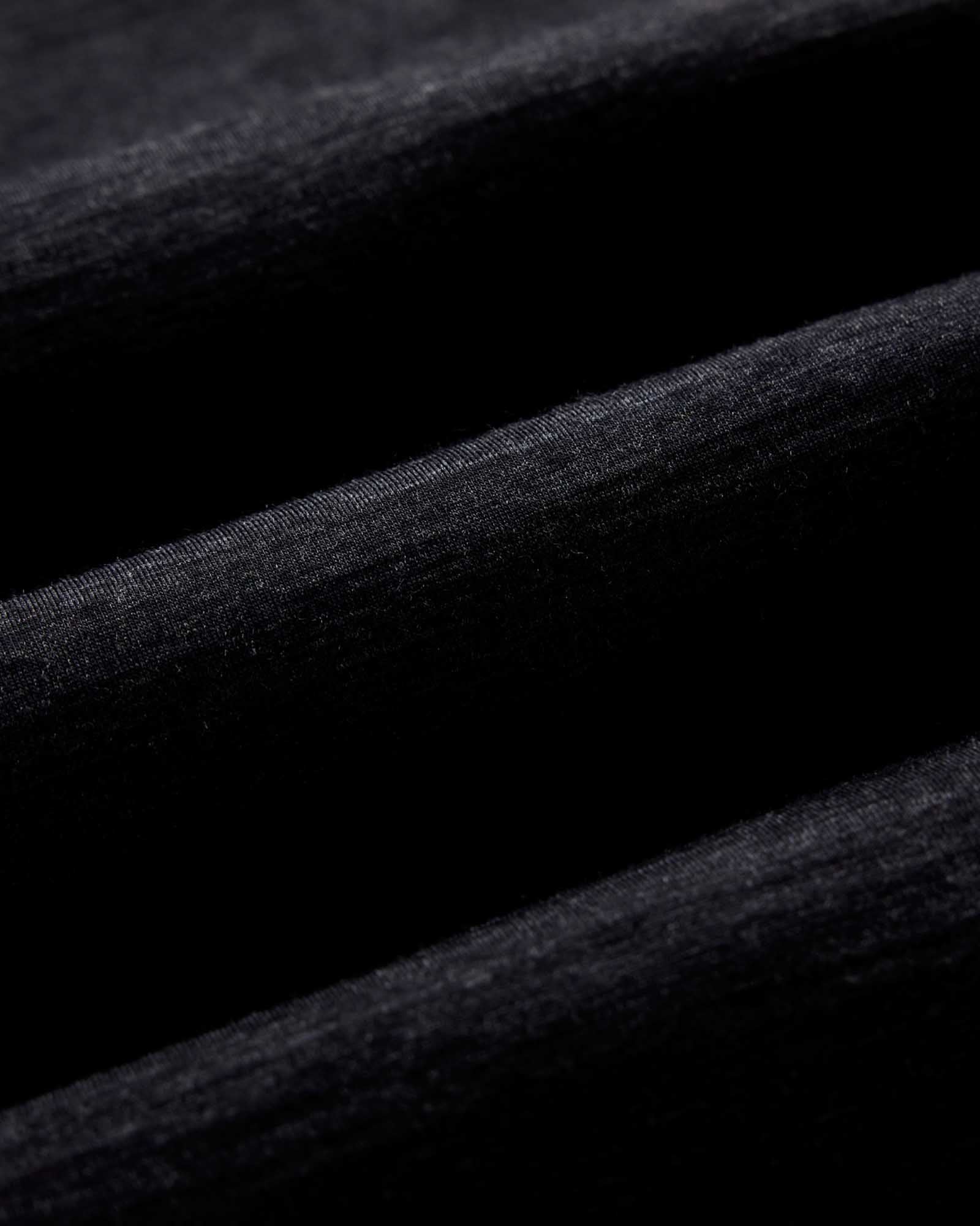 fit model standing wearing The Merino Tee in Heather Black, Knits by Taylor Stitch