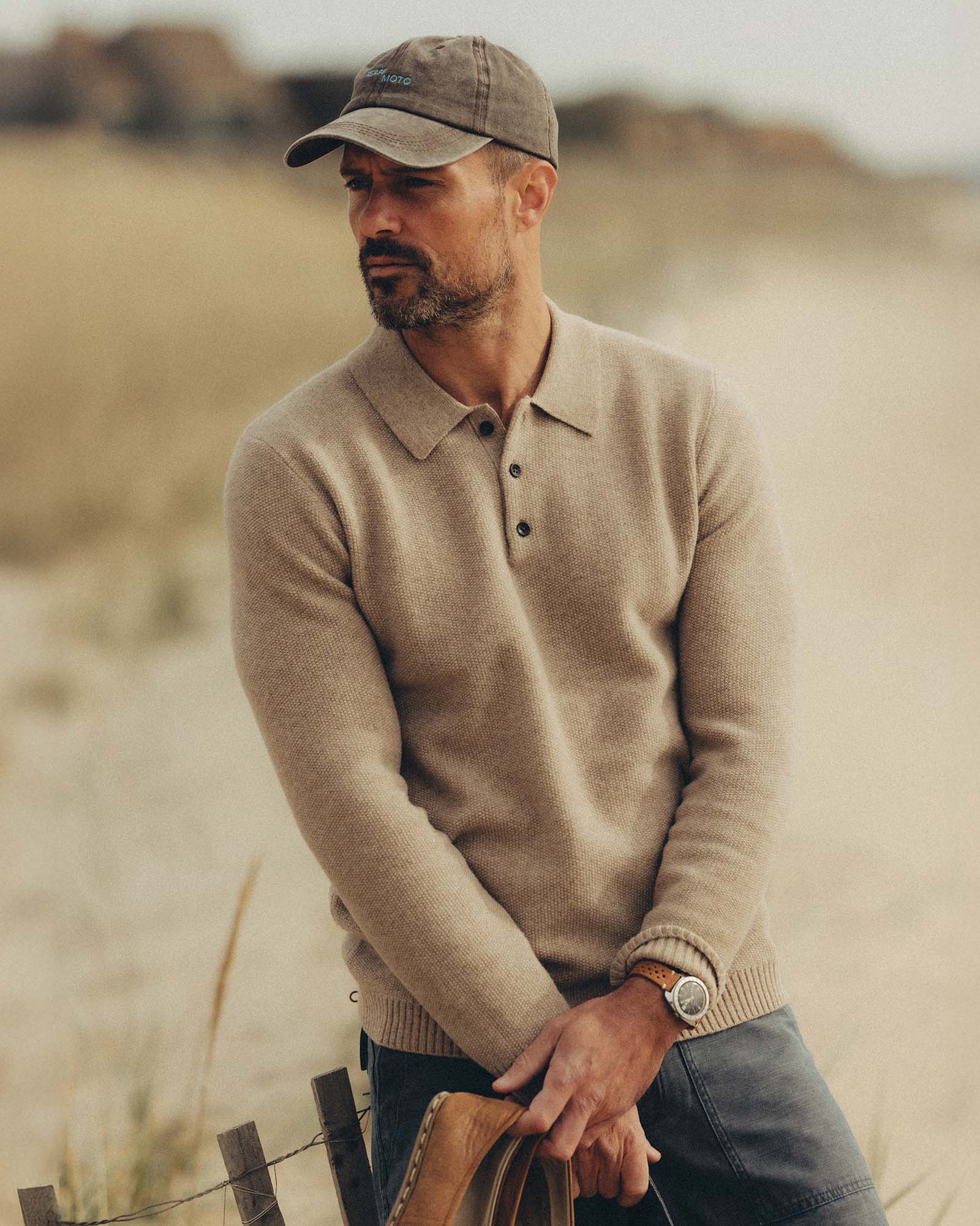 fit model posing in The Newton Sweater Polo in Heather Oatmeal, Knits by Taylor Stitch