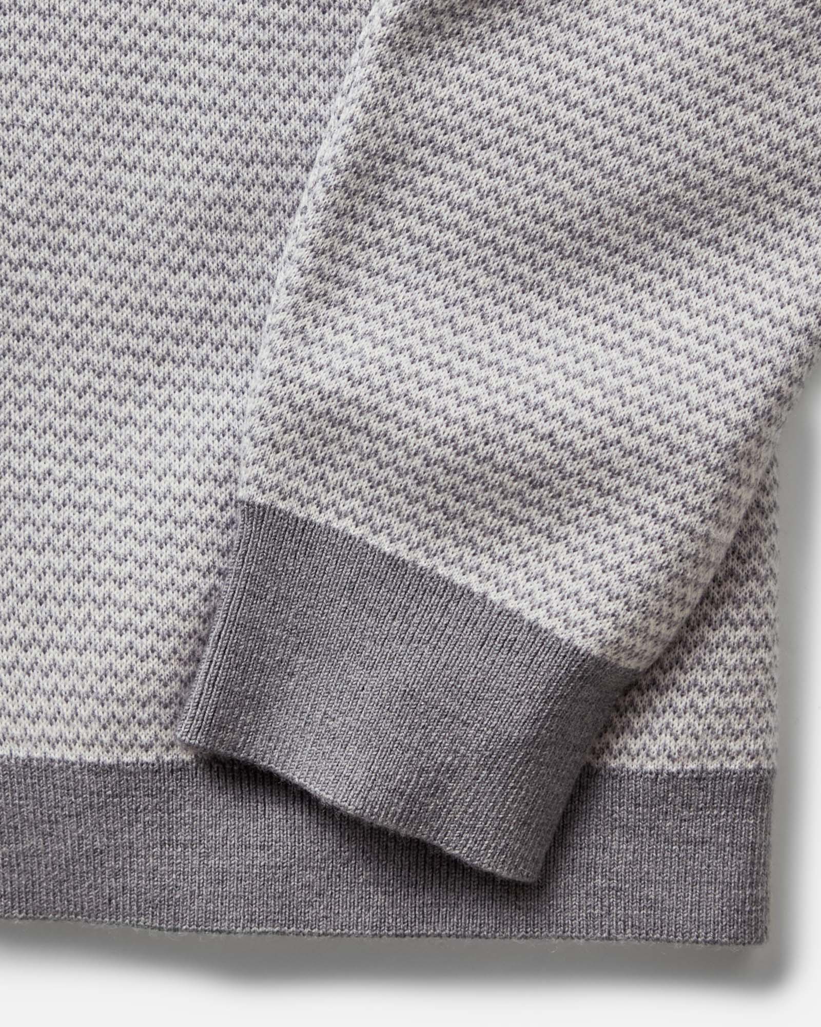 material shot of the sleeve on The Nichols Polo in Heather Grey Birdseye Merino, Knits by Taylor Stitch