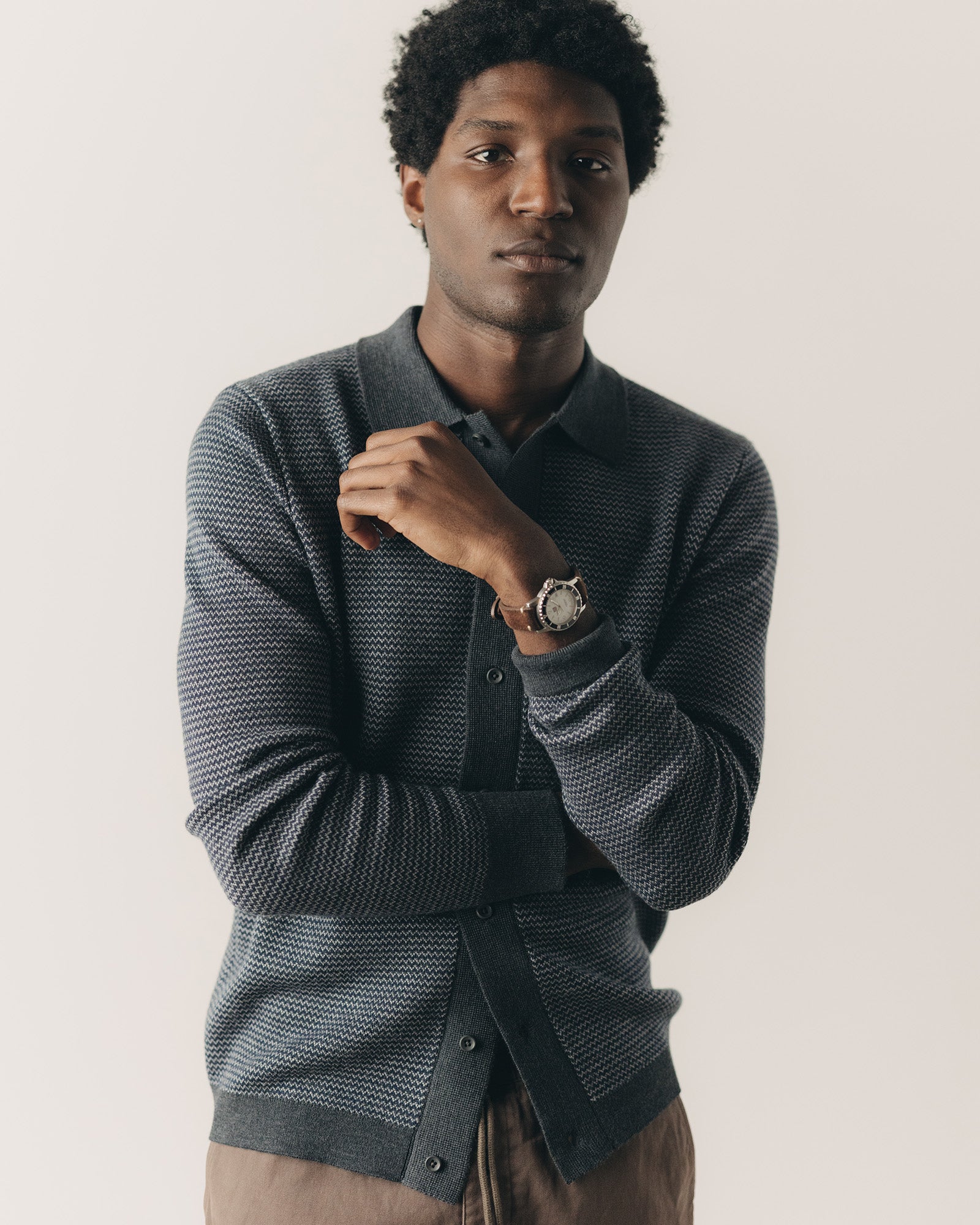 fit model posing in The Nichols Polo in Navy Birdseye Merino, Knits by Taylor Stitch