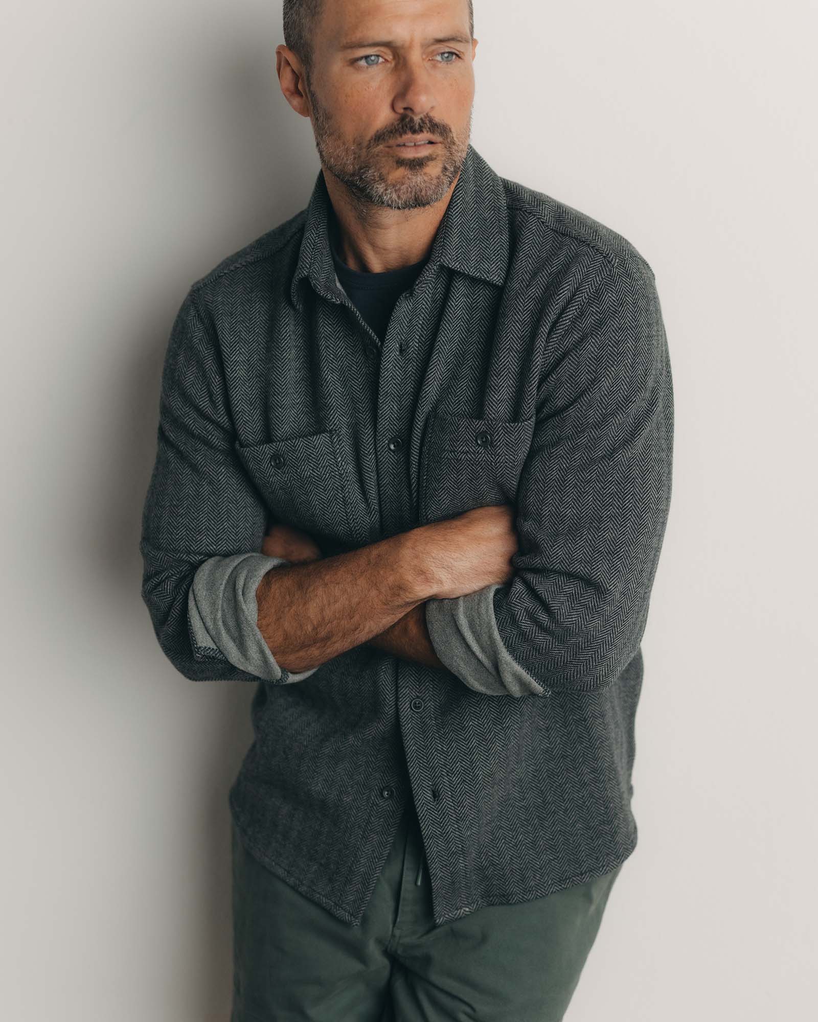 fit model posing in The North Shore Knit Shirt in Heather Coal, Knits by Taylor Stitch