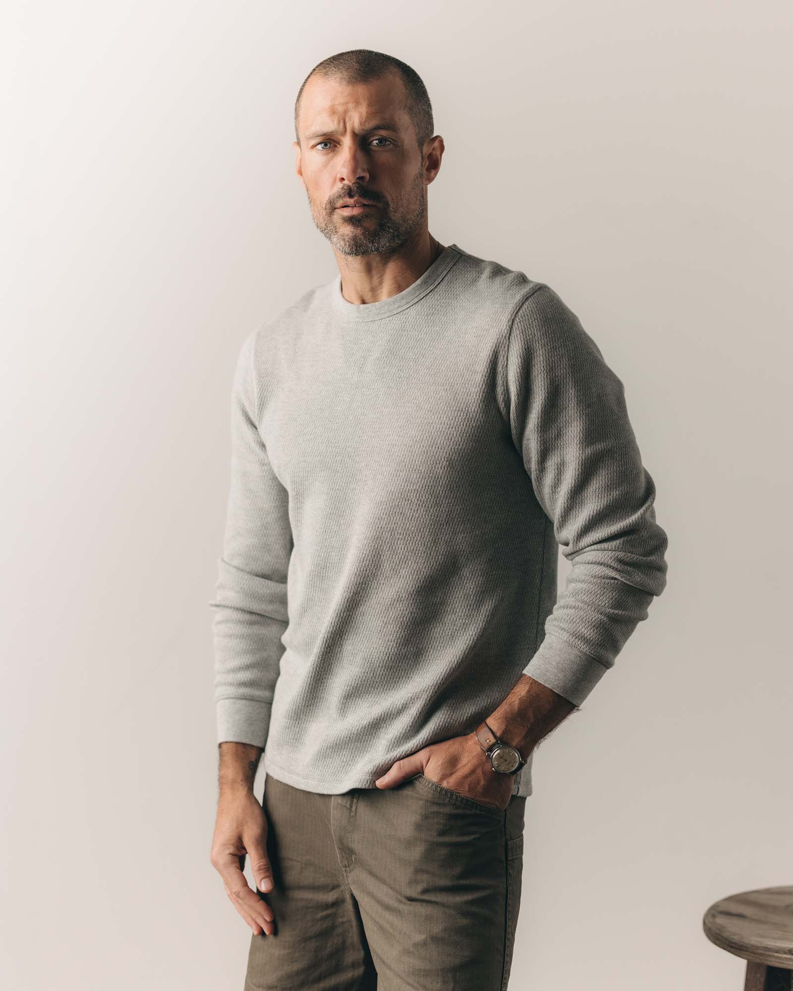 fit model sitting wearing The Organic Cotton Crew in Heather Grey Waffle, Knits by Taylor Stitch