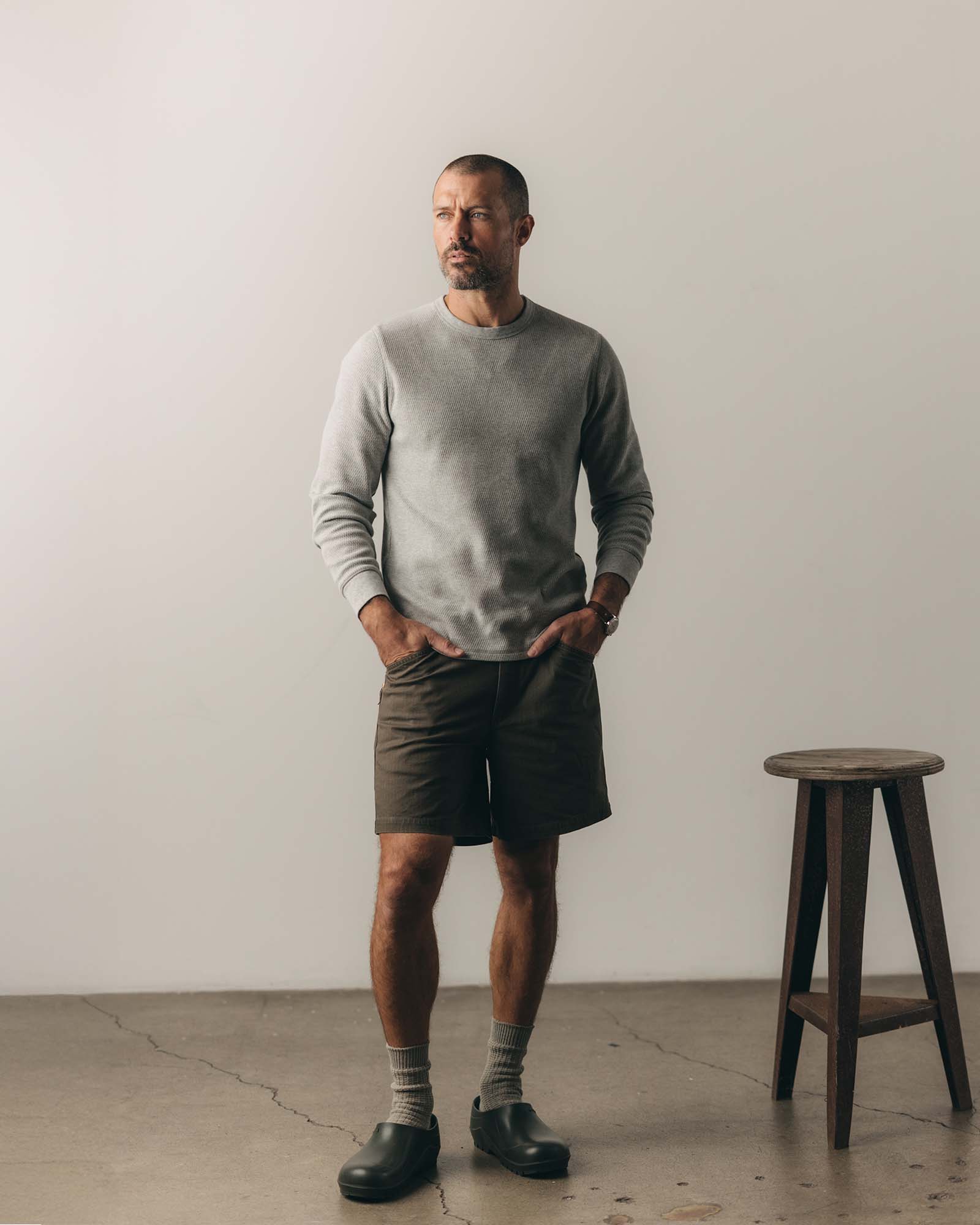 fit model pulling the sleeves on The Organic Cotton Crew in Heather Grey Waffle, Knits by Taylor Stitch
