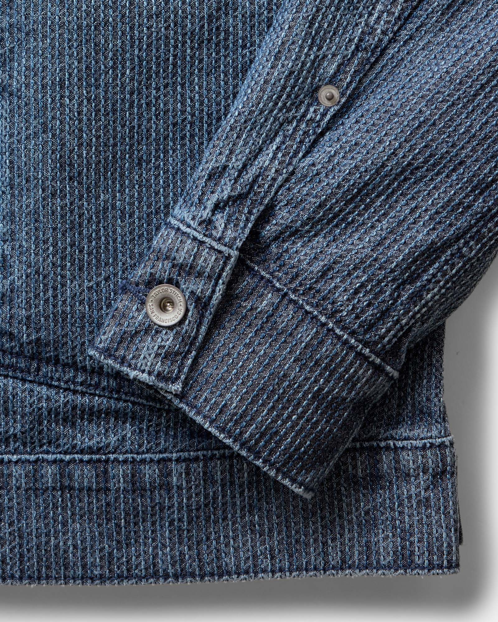 material shot of the sleeve on The Ryder Jacket in Japanese Washed Indigo Sashiko, Outerwear by Taylor Stitch