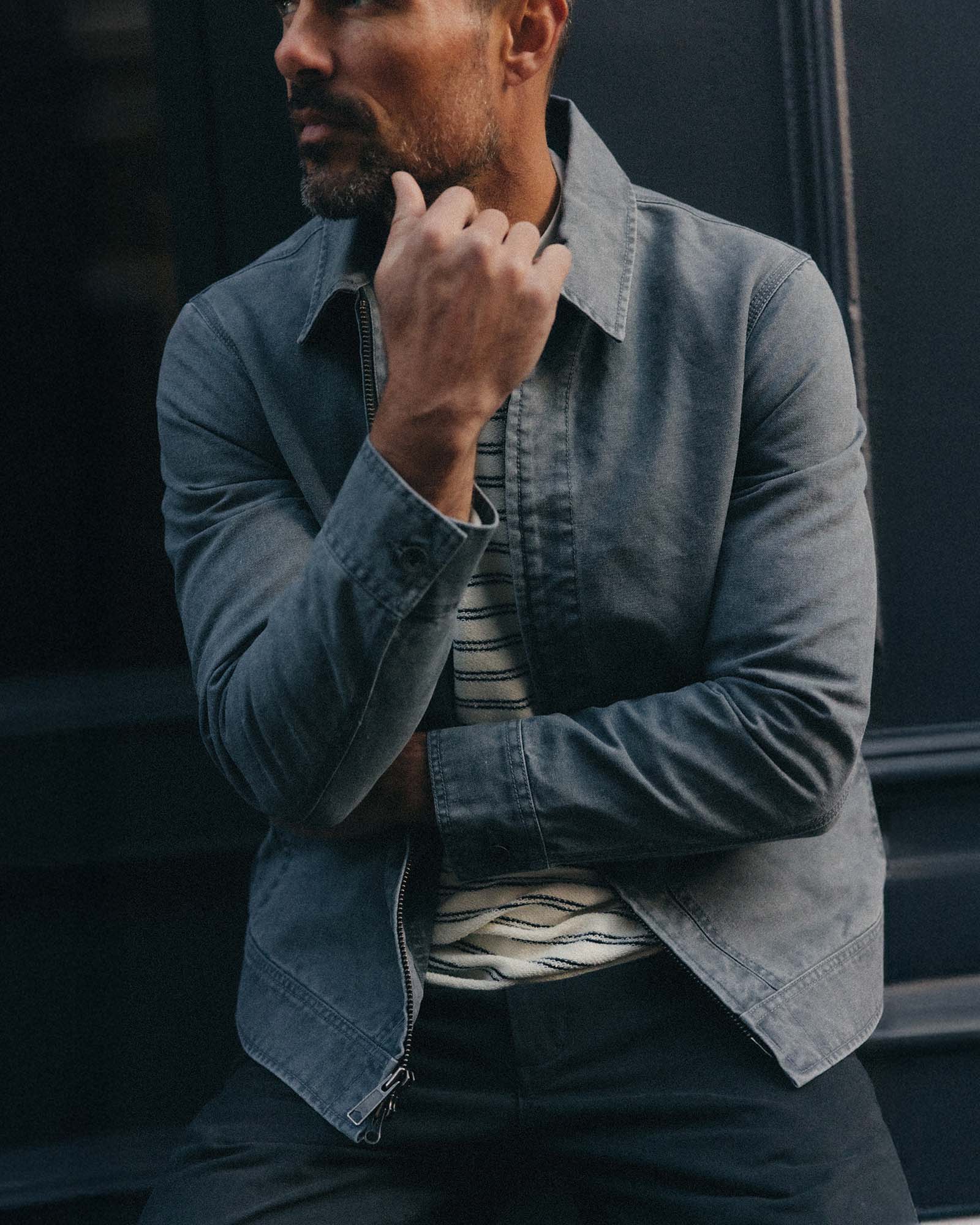 fit model sitting wearing The Shifter Jacket in Dark Grey Pigment Canvas, Outerwear by Taylor Stitch
