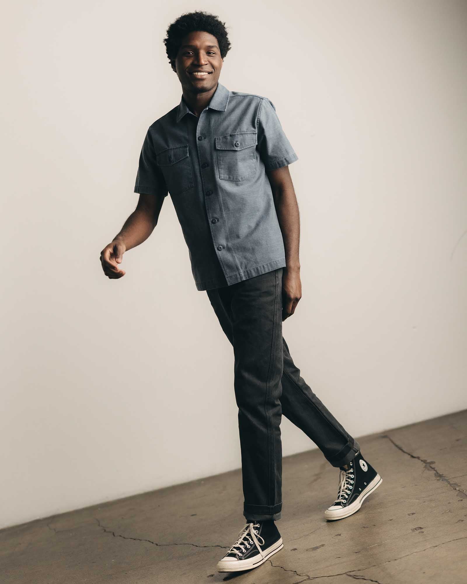 fit model walking wearing The Short Sleeve Surplus Shirt in Dark Navy Reverse Sateen, Wovens by Taylor Stitch