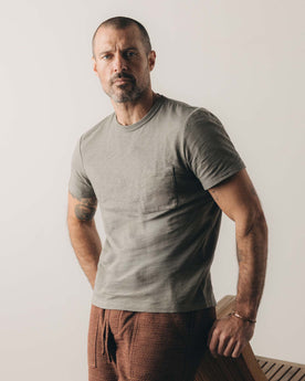 fit model posing in The Slub Tee in Smoked Olive, Knits by Taylor Stitch