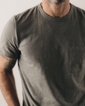 fit model showing off the pocket on The Slub Tee in Smoked Olive, Knits by Taylor Stitch