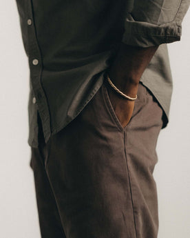 fit model with his hand in his pocket wearing The Straight Foundation Pant in Organic Espresso, Bottoms by Taylor Stitch