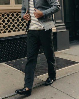 fit model walking wearing The Straight Foundation Pant in Organic Faded Black, Bottoms by Taylor Stitch