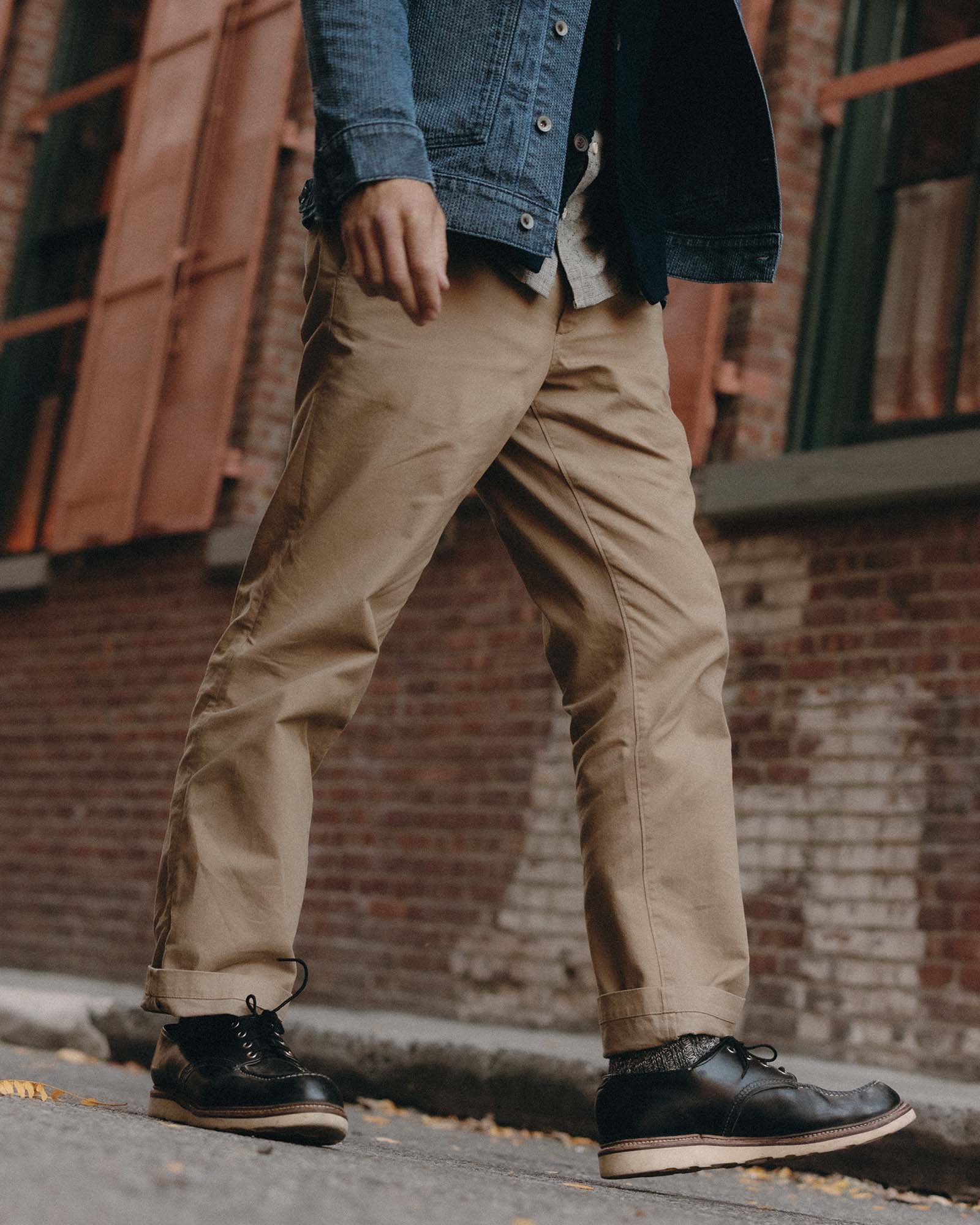 fit model walking wearing The Straight Foundation Pant in Organic Khaki, Bottoms by Taylor Stitch