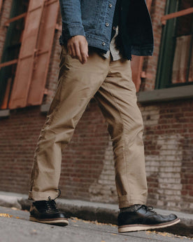 fit model walking wearing The Straight Foundation Pant in Organic Khaki, Bottoms by Taylor Stitch