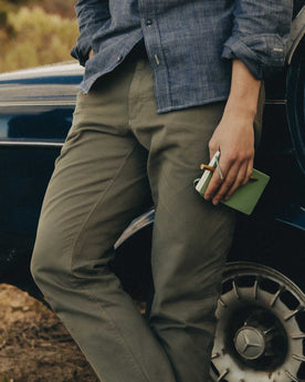 fit model leaning against the wall wearing, Bottoms by Taylor Stitch