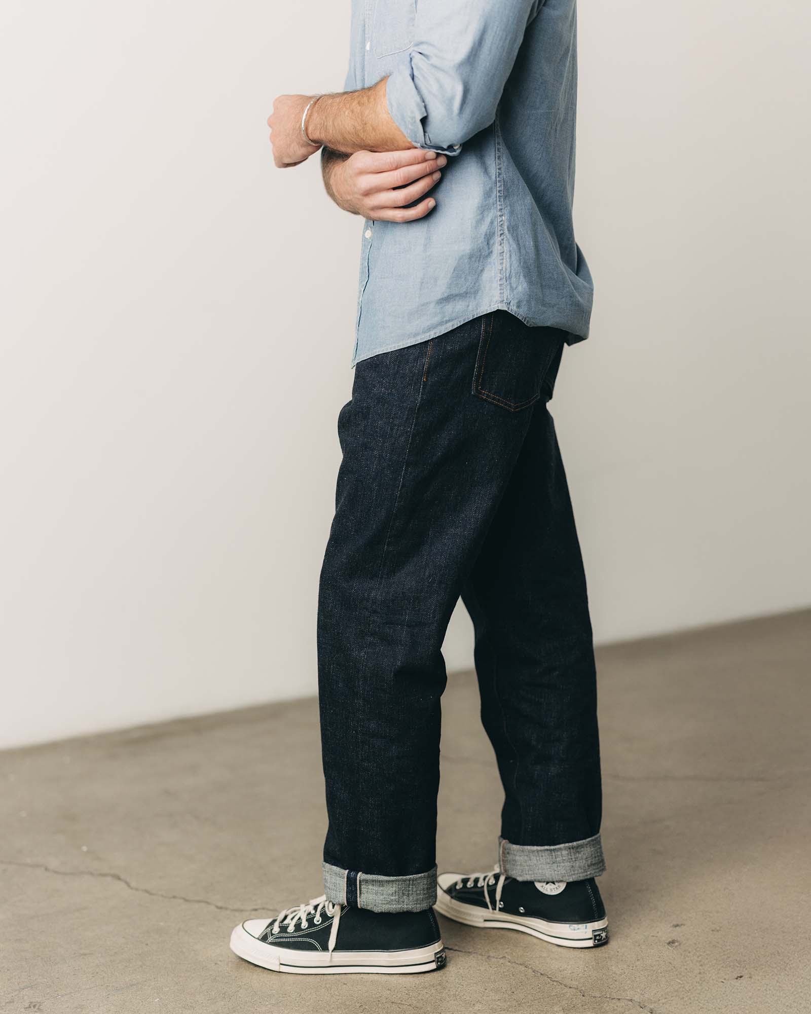 fit model posing in The Straight Jean in Rinsed Yoshiwa Selvedge, Bottoms by Taylor Stitch