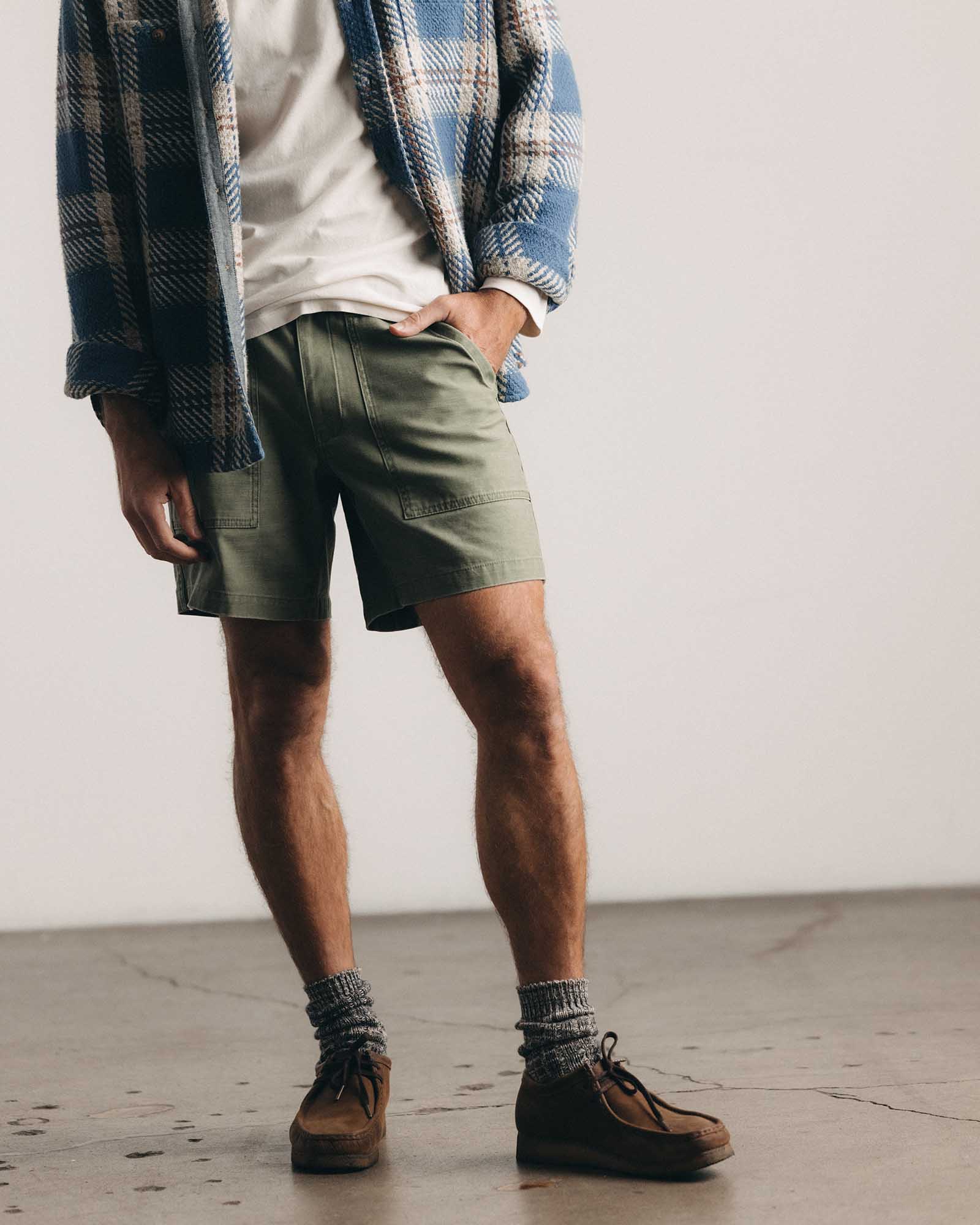 fit model posing in The Surplus Short in Field Olive Reverse Sateen, Bottoms by Taylor Stitch
