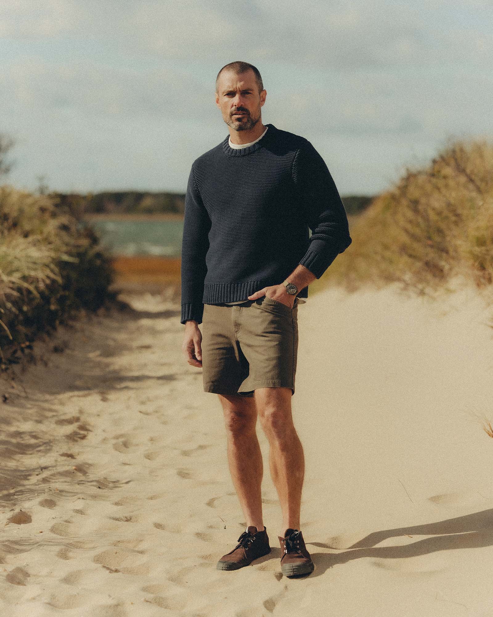 fit model posing in The Topsail Sweater in Dark Navy, Knits by Taylor Stitch