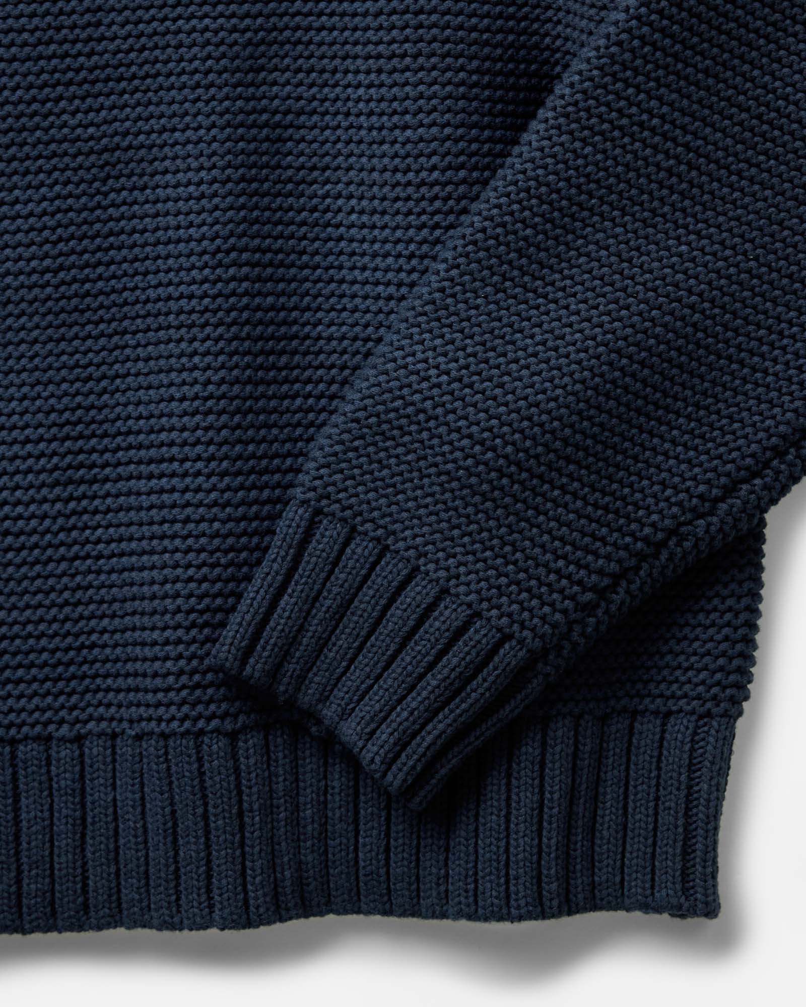 material shot of the sleeve on The Topsail Sweater in Dark Navy, Knits by Taylor Stitch
