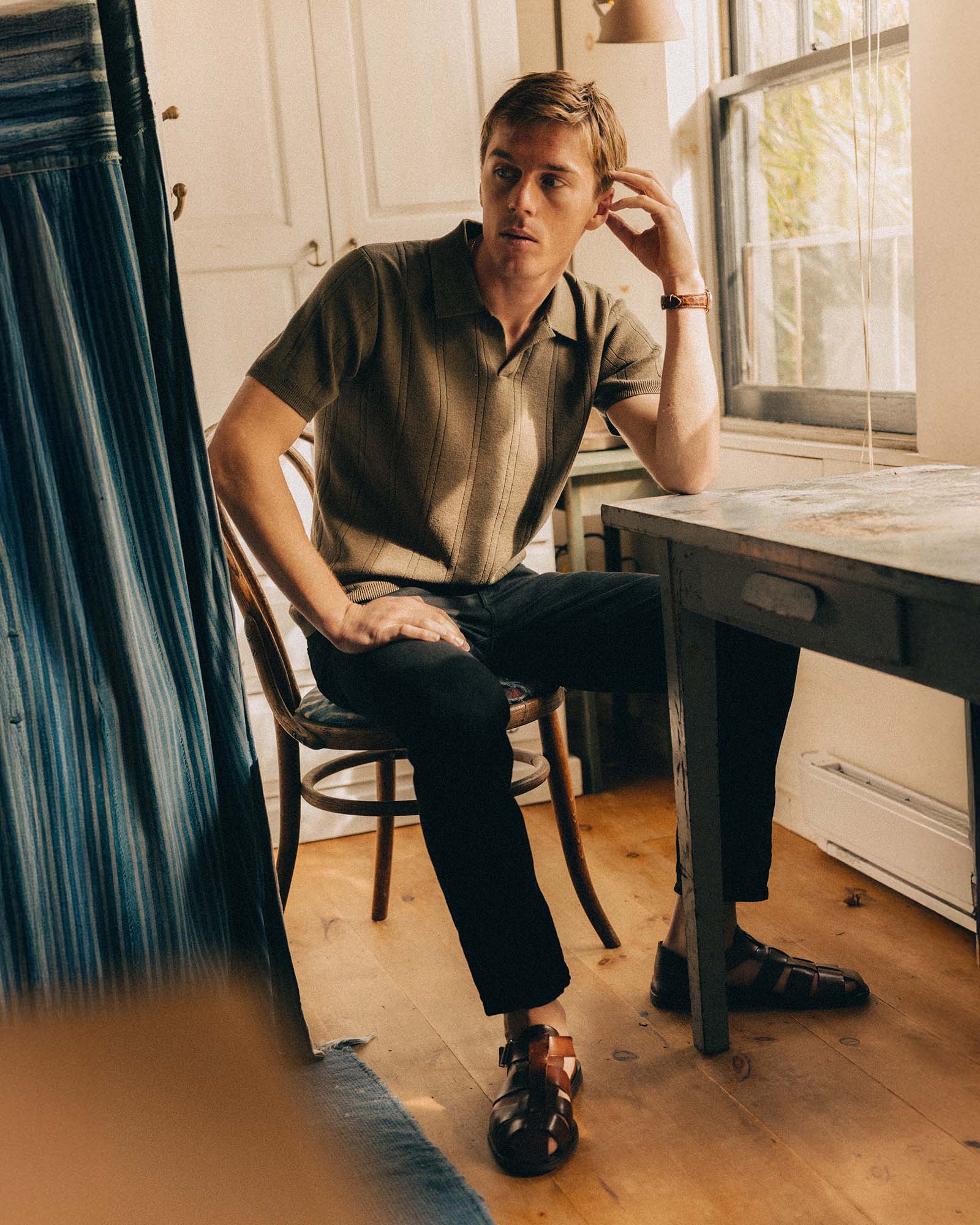 fit model sitting wearing The Valencia Sweater Polo in Heather Cilantro Rib, Knits by Taylor Stitch