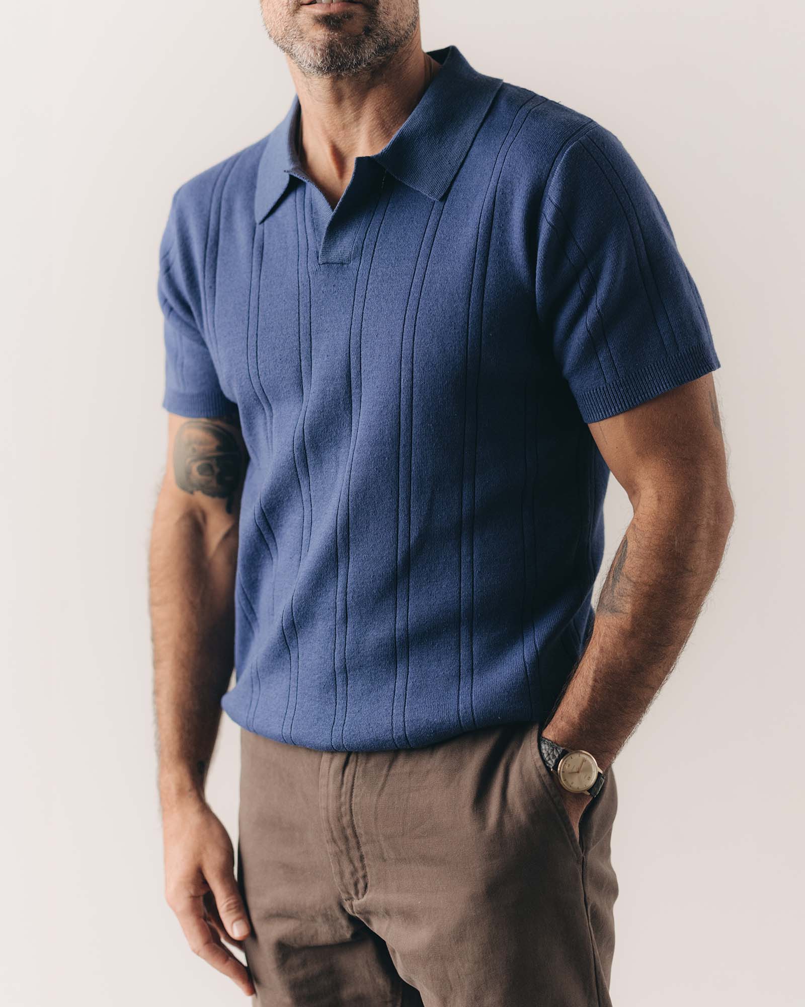fit model posing in The Valencia Sweater Polo in Heather Clear Blue Rib, Knits by Taylor Stitch