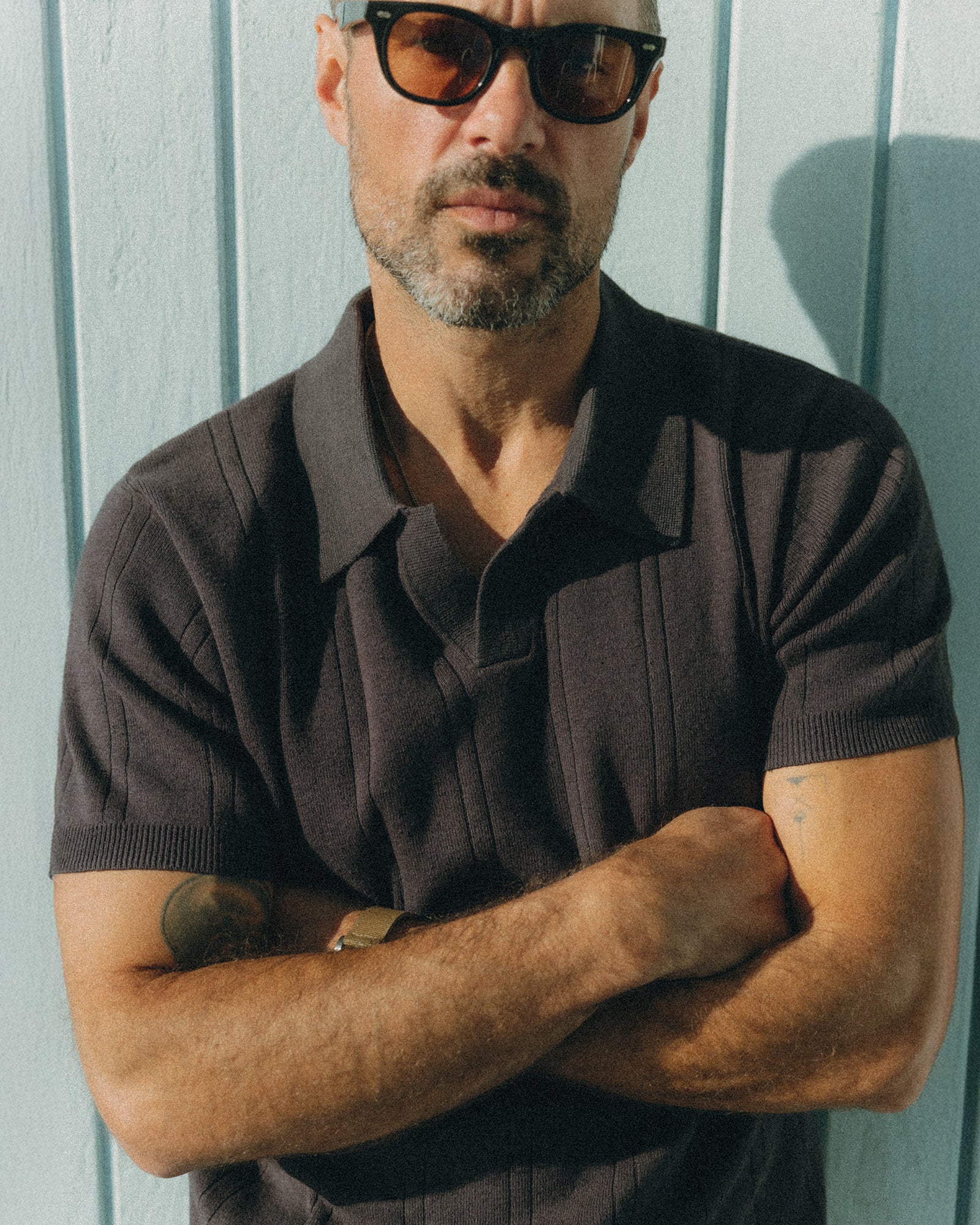 fit model posing in The Valencia Sweater Polo in Heather Coal Rib, Knits by Taylor Stitch
