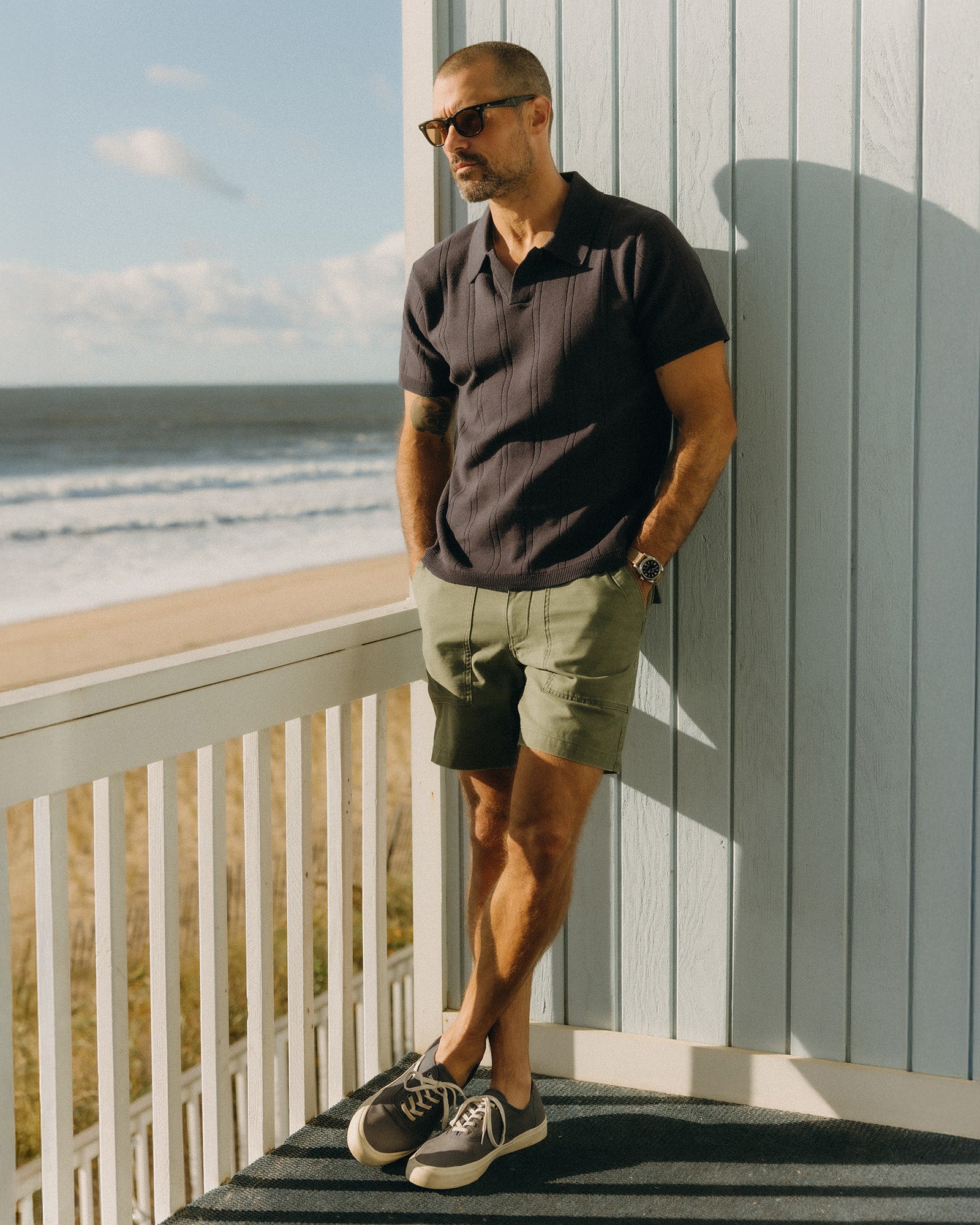 fit model showing off The Valencia Sweater Polo in Heather Coal Rib, Knits by Taylor Stitch