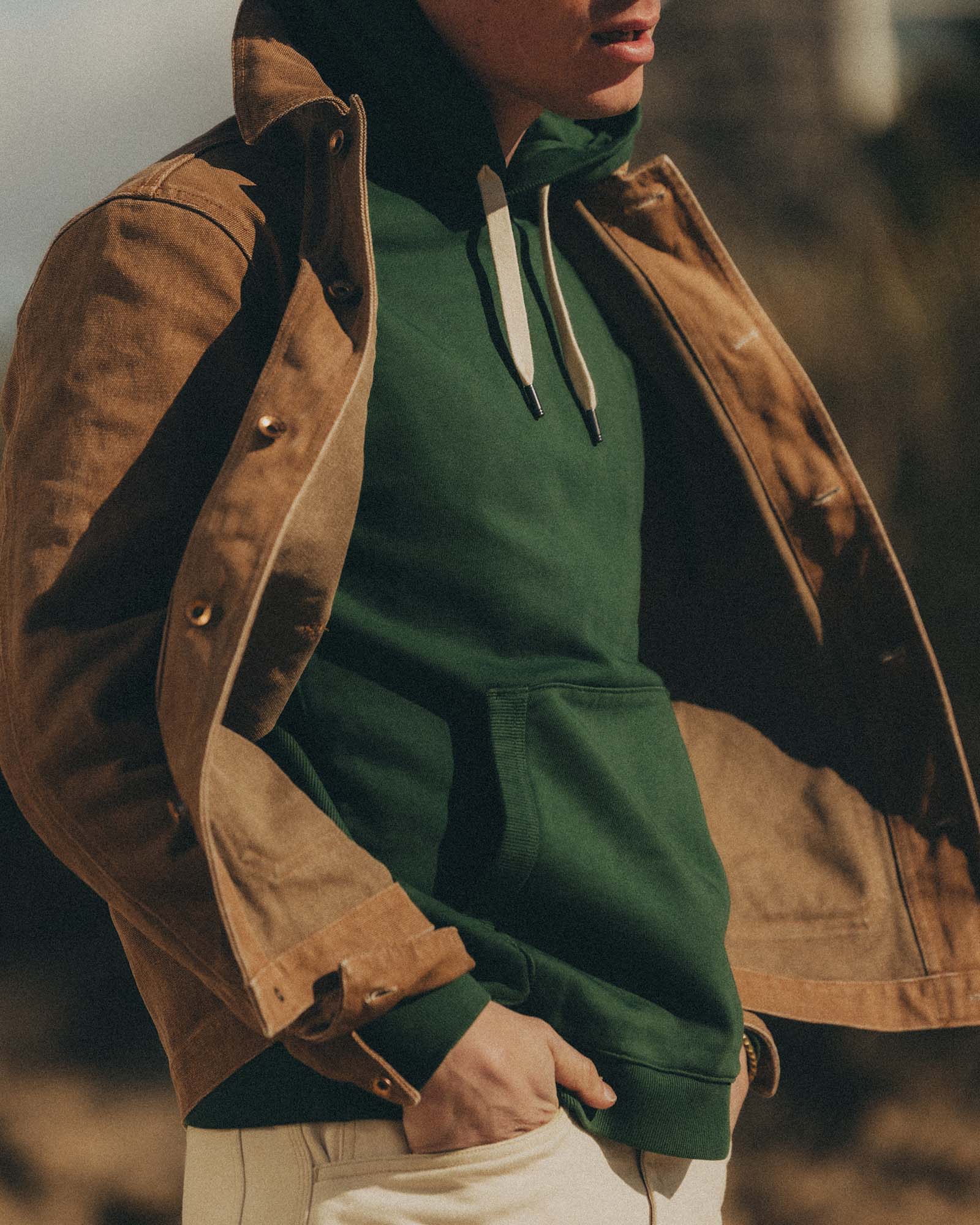 fit model posing in The Shop Hoodie in Ivy French Terry, Knits by Taylor Stitch