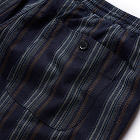 material shot of the rear button pocket on The Apres Short in Indigo Stripe